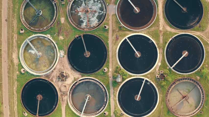 Aerial top view of round polls in wastewater treatment plant, filtration of dirty or sewage water | Shutterstock HD Video #1053899702