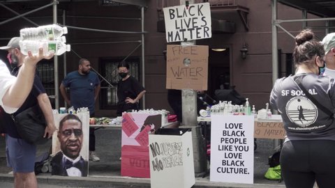 NEW YORK - JUNE 6, 2020: Black Lives Matter volunteers providing bottled water and fruit snacks at protest for police killing of African American George Floyd, near Washington Square Park, NYC.