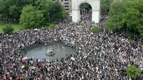 NEW YORK - JUNE 6, 2020: protest of police killing of Black American George Floyd, demonstrators fill Washington Square Park with signs in New York City NYC.