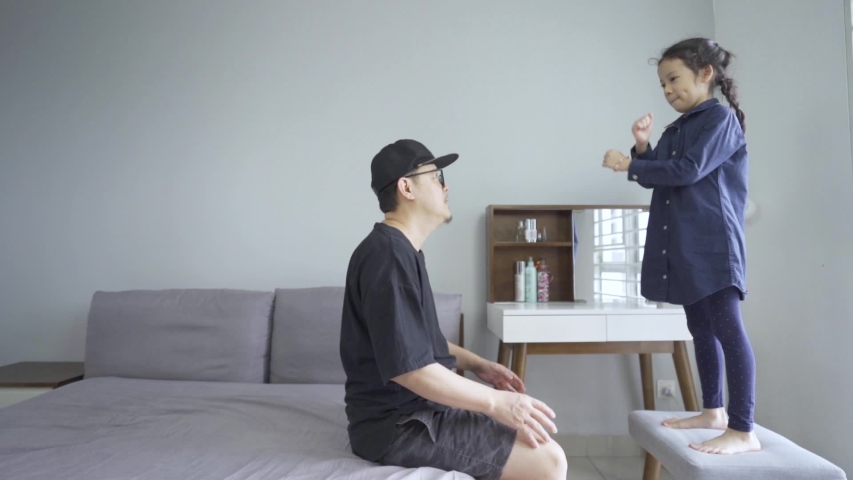 Little asian daughter jump to father on bed, happy family lifestyle concept, slow motion HD