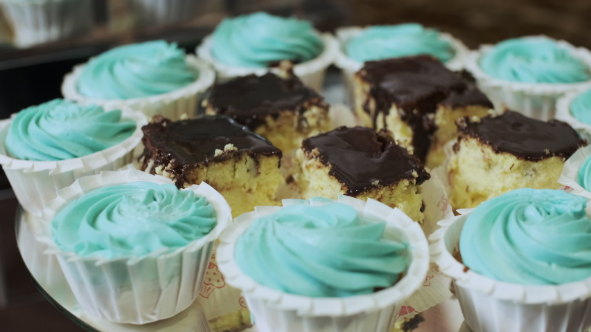 Close Up Of Turquoise Cupcakes And Cheesecakes With Chocolate On A Wedding Candy Bar