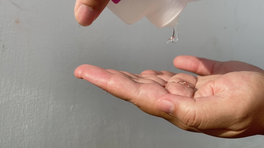 4K Close up of hand rub procedure by using alcohol sanitizer. Good example to show the importance of hand hygiene during Covid - 19 pandemic | Shutterstock HD Video #1053909605