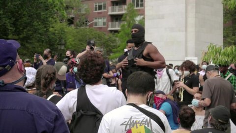 NEW YORK - JUNE 5, 2020: masked militant activist speaking to crowd at Black Lives Matter rally in Washington Square Park, New York City, NYC.