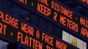 Closeup view of a news ticker reminding pedestrians to keep 2 meters apart from each other. Social distancing was a common practice to slow the spread of COVID-19 during the pandemic of 2020.  	 - Powered by Shutterstock - Get 15% off with code: PIKWIZARD15