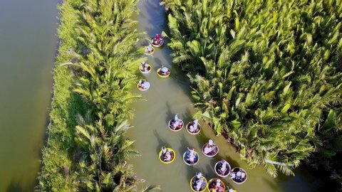 Coconut village eco tour in Hoi An Vietnam with Bamboo basket boats on Thu Bon River, Aerial pan up shot