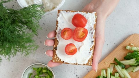 Whole grain rye cracker with cream cheese and cherry tomatoes. Healthy vegetarian snack or healthy breakfast