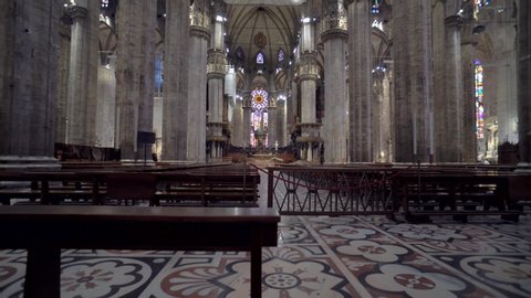 Italy, Milan, June 6, 2020: Interior inside the Milano Cathedral. Tourists visiting the architecture of the famous Italian church. Statues and columns inside the Duomo Cathedral, Italy. Steadicam shot