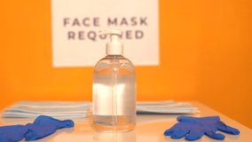 Stock video of the entrance of a shop where it is required to wear a medical mask and use disinfectant gel to prevent the spread of covid-19.