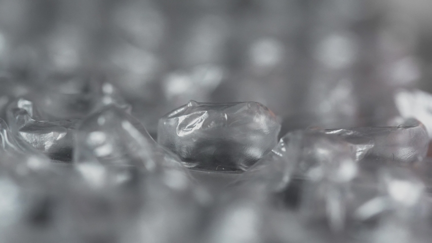 Finger pops bubble by clicking on wrap film plastic packaging material, macro. Nervous system concept. Type of tactile amusement playing. Calming effect. Give pleasure. Satisfaction. Polyethylene Royalty-Free Stock Footage #1053928823