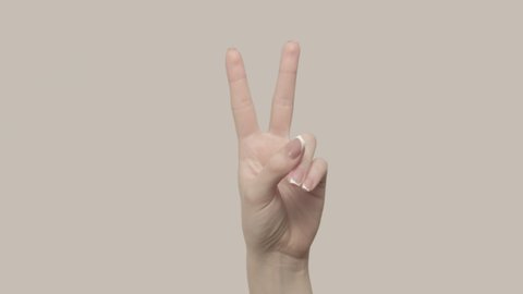 Air quotes. Female fingers showing quotation marks. Set of 2 hand gestures isolated on gray background.