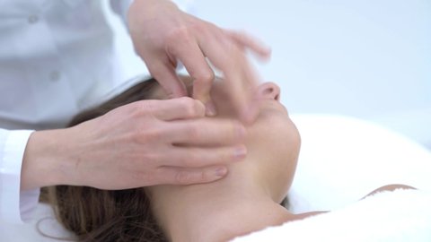 Close-up 4K video of woman enjoying japanese face massage in professional salon