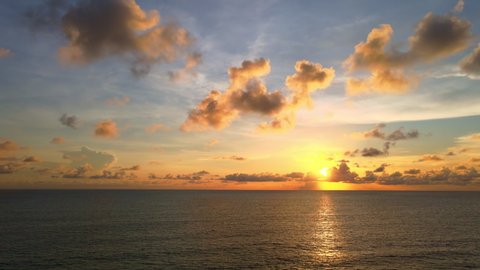4K UHD Aerial drone view Beautiful sunset over tropical beach with clouds 
In the middle of the sea