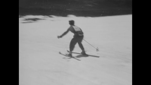 CIRCA 1949 - Men and women go skiing on a slalom course in Oregon.