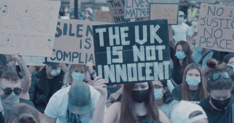Bristol, UK - June 07 2020: Woman holding "UK is not innocent" at Black Lives Matter march