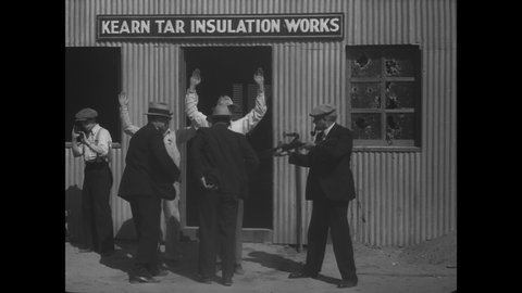 CIRCA 1932 - The Sheriff's deputies engage in a shootout in a distillery disguised as an insulation works building in Downey, California.