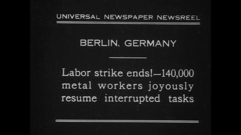 CIRCA 1930 - Men and women employed as metal workers in Berlin, Germany happily return to work after a labor strike.