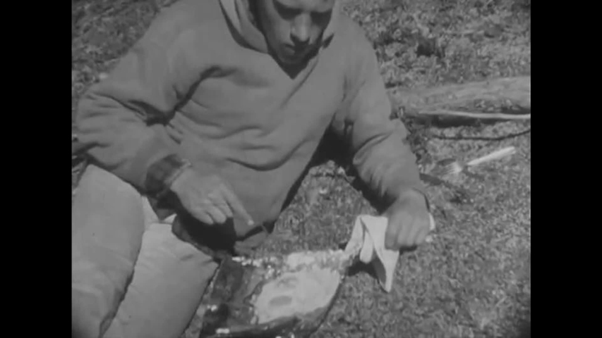 CIRCA 1950s - Men fish for trout in Canada in the 1950s.