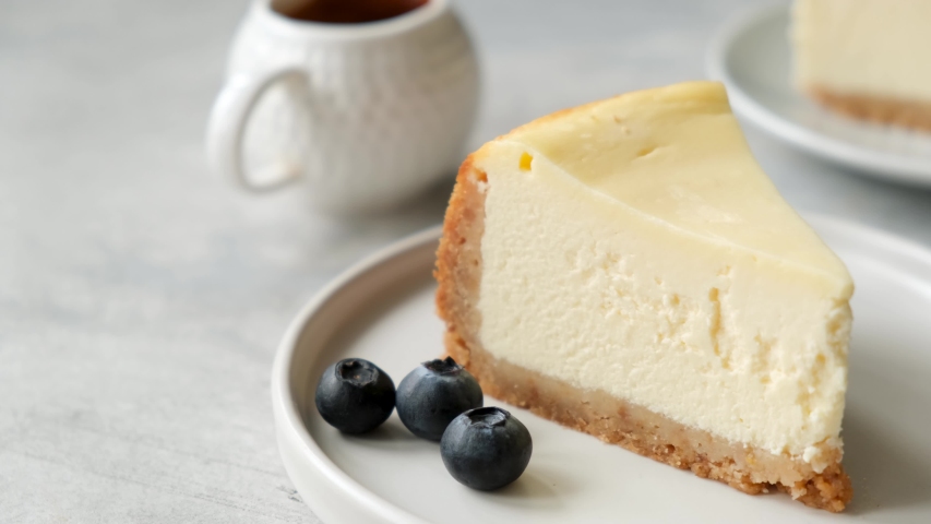 Slice of cheesecake with blueberry sauce. Serving cheesecake with blueberry jam