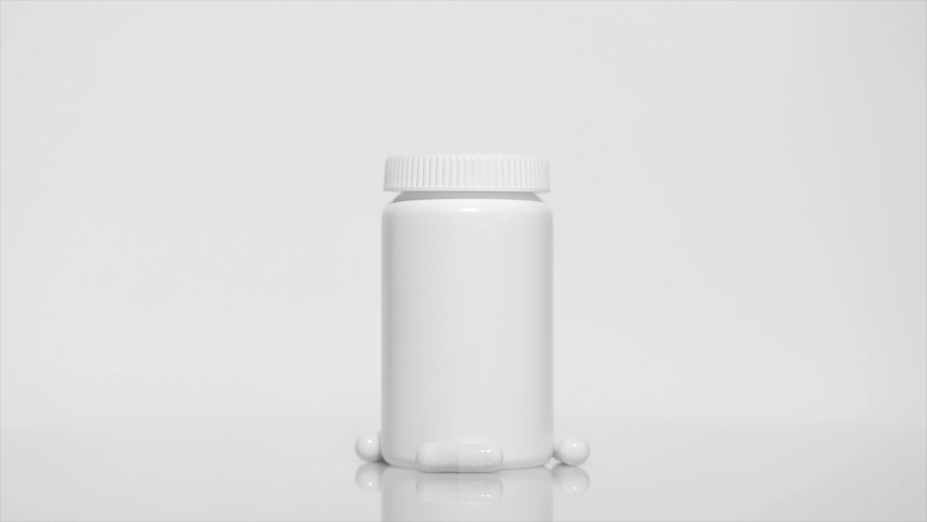 Plastic medical bottle with pills on a white table, rotation 360 degrees. White background.Ultra high definition 3840X2160.4K resolution Royalty-Free Stock Footage #1053986135