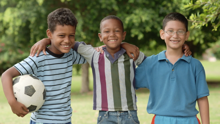 Young people and sports, portrait of three happy children with football looking at camera. Summer camp fun with boys and friends as soccer team smiling | Shutterstock HD Video #1053992270
