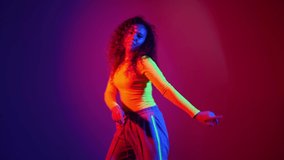 African-American woman dancing against color background