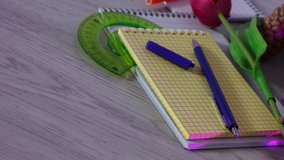 Office and school supplies on wooden table background.