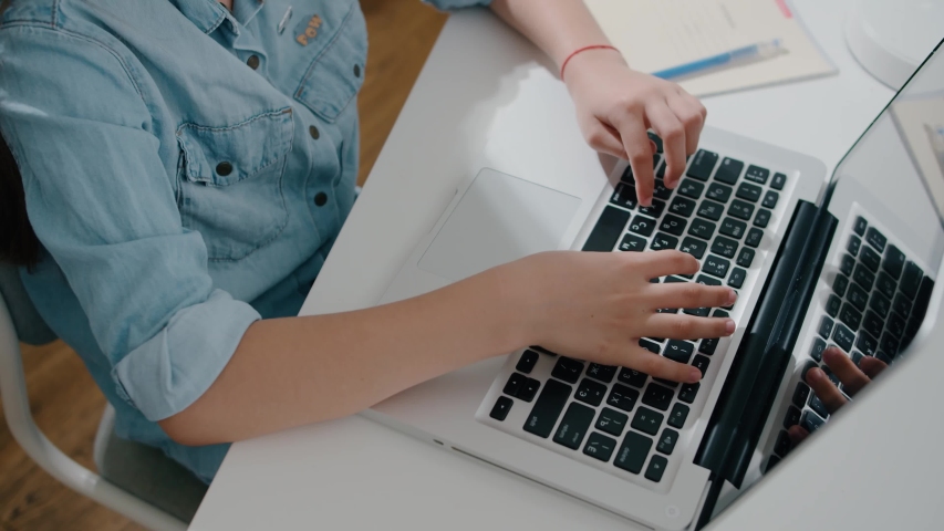 Young woman college university student using laptop computer at desk, female hands typing on notebook keyboard studying working with pc, distance education concept slow motion close up Royalty-Free Stock Footage #1054001780