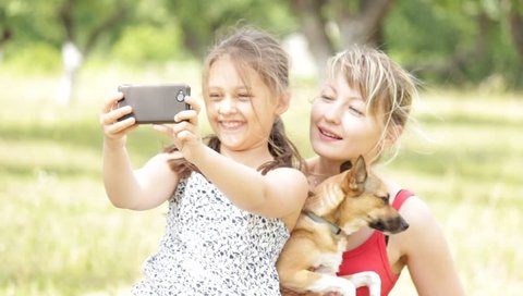 girl takes selfie with mom and dog
