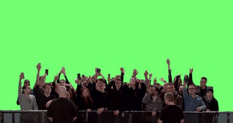 GREEN SCREEN CHROMA KEY Model released, Front view of a crowd dancing and cheering at a concert or a show behind control barrier. Shot on RED Helium 8K Prores 4444