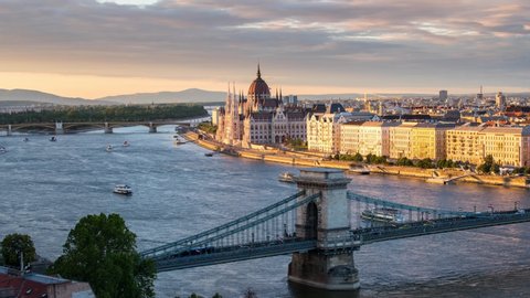 Time lapse with view of Budapest's Parliament building, Chain bridge and Danube river at sunset.