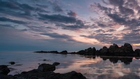 Time lapse with colorful sunrise sky at rocky coastline and calm summer sea, the Black Sea coast, Bulgaria