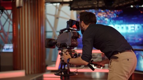 Cameraman Working In TV Studio Video Production Filming Interview. Television Operator On TV Broadcasting Production Channel. Camera Operator On News Room Shoot Media Movie. Making TV Show Or Film