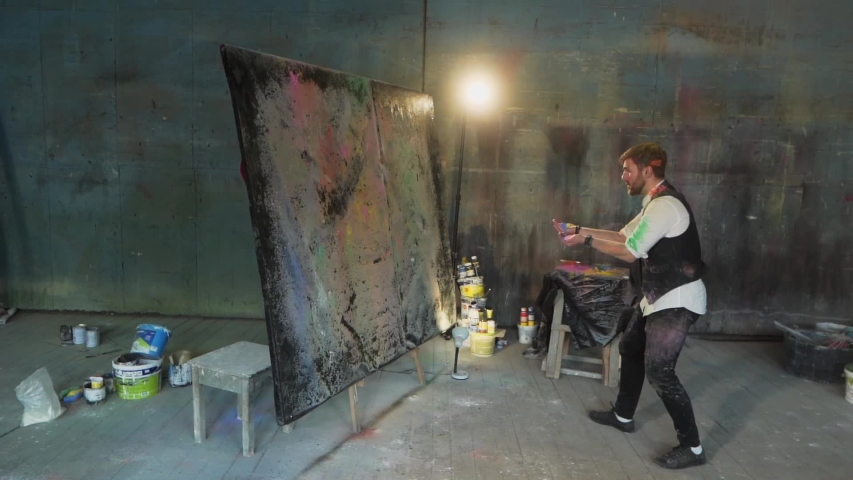 general plan the artist paints a picture throwing dry paint on the picture