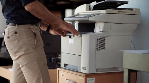 Businessman Printing Document On Workplace.Businessman Working In Office And Preparing Documents For Signature.Man Using Printer Or Scanner In Office.Man Finger Press Buttons On Multifunctional Copier