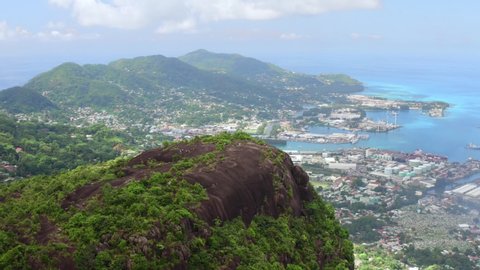 Aerial view of scenic mountain pick with city on background. Copolia trail, Seychelles.