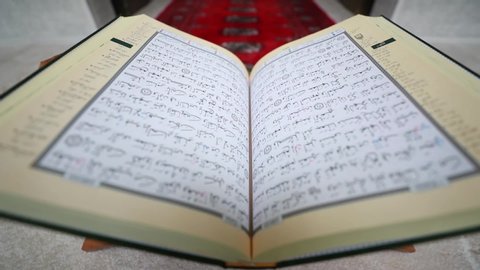 Sarajevo, Bosnia and Herzegovina, May 12th 2020.: A slow motion shot showing a Quran lying in front of the mihrab on a Quran holder, the shot is approaching the Quran