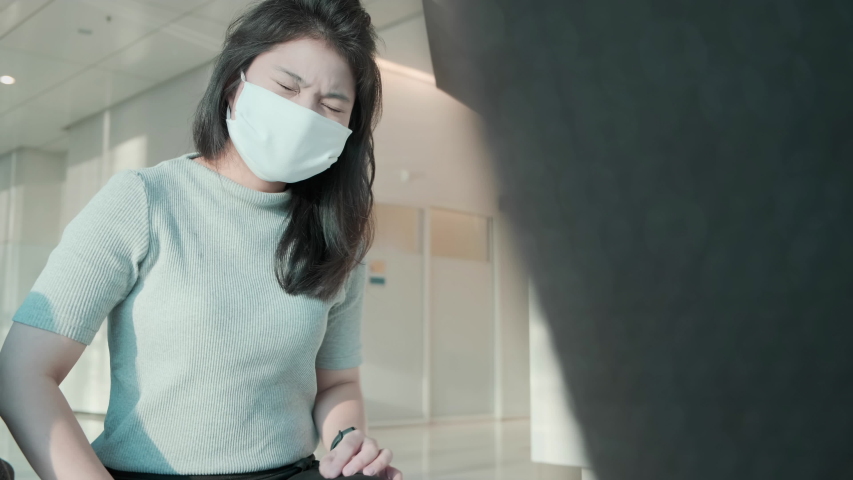 sick asian female face mask protection cough and sneeze with high temperature headache feel bad corona virus covid 19 infected sit wait at hospital clinic waiting area cinematic color tone Royalty-Free Stock Footage #1054045394