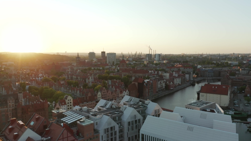 Aerial View: Historically and Culturally rich Polish City at Sunset. Beautiful Old City With Medieval Churches and Cathedrals. River Runs through the City Gdansk, Poland. | Shutterstock HD Video #1054053869
