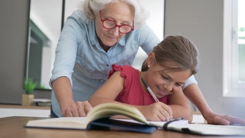 grandmother helping grandkid with homework