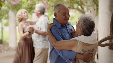 Happy elderly couple dancing latin american dance on holiday. Senior men and women as skillful dancers at party. Active retirement, recreation fun and leisure activity for old people
