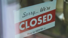 Closed sign hang on the glass in pandemic time in 4K Slow motion 60fps - Powered by Shutterstock - Get 15% off with code: PIKWIZARD15