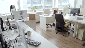 Dolly-out shot of desks and computers in empty office amidst covid-19 pandemic - Powered by Shutterstock - Get 15% off with code: PIKWIZARD15