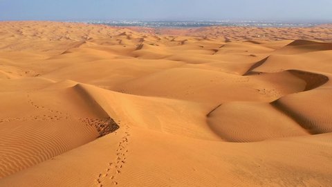 Aerial shot of sand dunes in the desert. Flying over endless sand dunes,Oman