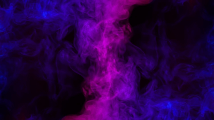 Smoke on a black background. Bright colorful smoke. Blue, raspberry, red, purple background. Beautiful abstract background. smoke texture. Pattern. Royalty-Free Stock Footage #1054064876