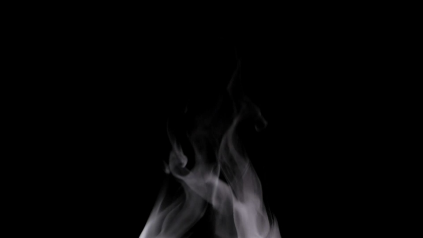 White steam spins and rises from the pan. White smoke rises from a large pot, which is located behind the frame. Isolated seamless loop black background. | Shutterstock HD Video #1054067363