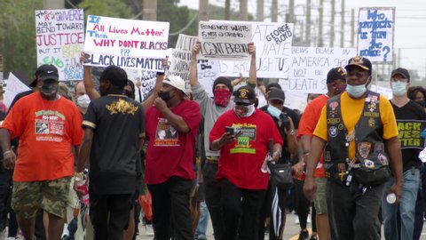 Cocoa, Florida USA - June 2020: Black Lives Matter Protest march to denounce killing of George Floyd during COVID-19 pandemic. Peaceful BLM crowds of protesters march with signs in the streets. Audio