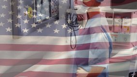 Animation of US flag waving over female doctor wearing protective clothing and face mask standing in a surgery room, looking at the x ray scan in the background. Medicine public health pandemic corona - Powered by Shutterstock - Get 15% off with code: PIKWIZARD15