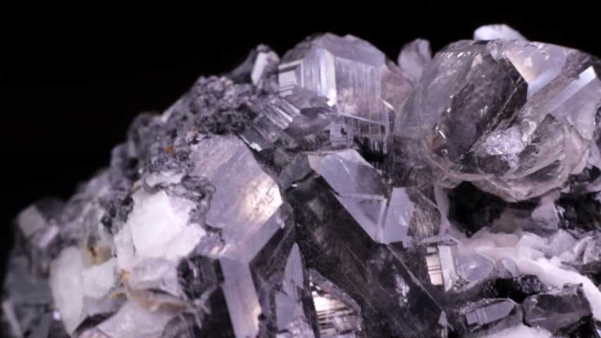 Cerussite crystals macro video slowly rotating over a black background. Also known as lead carbonate.