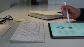 Pretty business woman working on tablet computer and analyzing a marketing report in her office on white desk using a pen - Powered by Shutterstock - Get 15% off with code: PIKWIZARD15