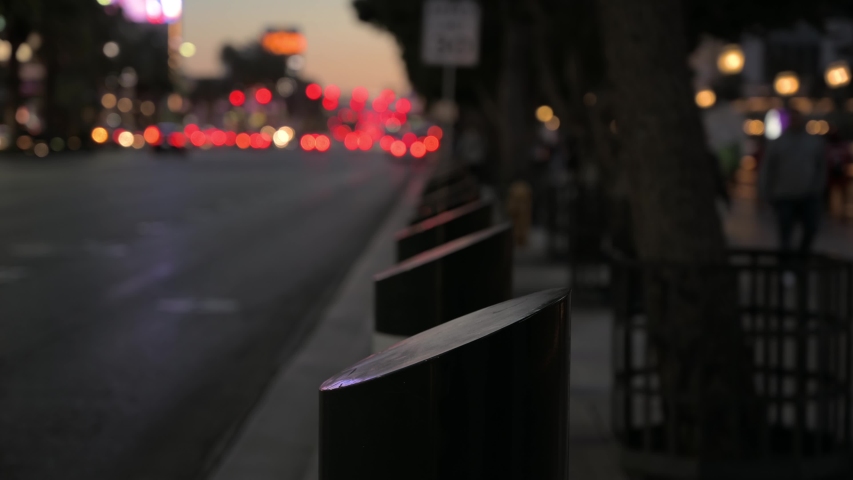 A close up view of street pillars on the Las Vegas strip around the Bellagio resort walk way with traffic passing by. 